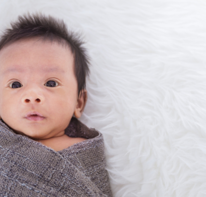 Closeup portrait of asian happy baby wrap up in gray blanket over white background with copy space, Family love newborn healthcare medecal concept panoramic banner